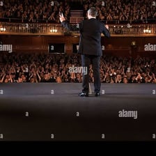 An audience applauding a performer after a show.