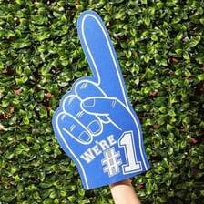 A foam cheering hand shown alongside a farm worker