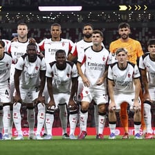 AC Milan football players on a soccer field.