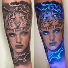 A tattoo fluoresces under ultraviolet light.
