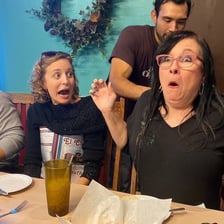 Person reacting with surprise after a minor mishap.