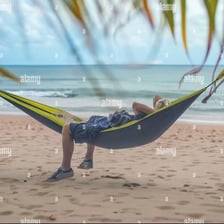 A person resting in a hammock during the afternoon.