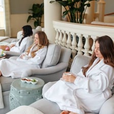 A spa relaxation area with robes and lounge seating