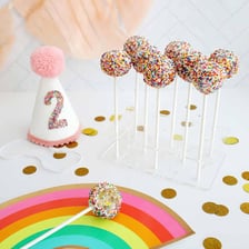 A decorated cake pop mounted on a stick.