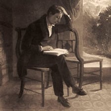 A poet writing at a desk.