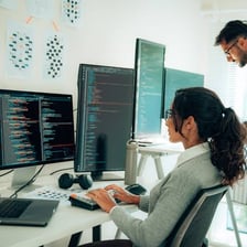 An IT support technician helping someone with a computer