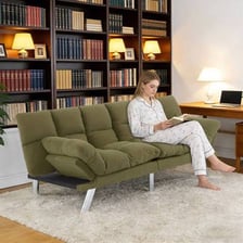 A futon arranged as a bed in a guest room