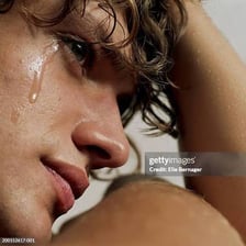 A person with tears on their face.