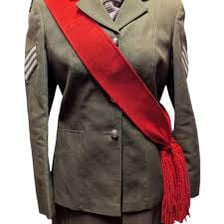 A person wearing a ceremonial sash across the shoulder.