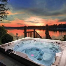 Several outdoor hot tubs filled with bubbling water