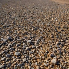 A rough road covered with loose gravel.