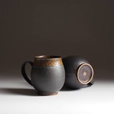 A mug filled with dark brewed coffee