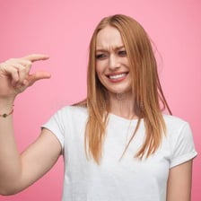 A person smiling during a quiet, playful laugh