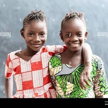 Two sisters smiling together.
