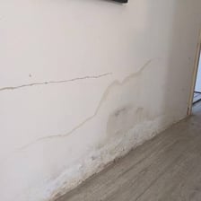Water slowly entering through a crack in a wall