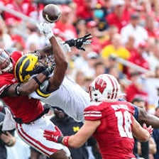 Michigan Wolverines and Wisconsin Badgers teams competing in a sporting event.