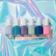 Several Essie nail polish bottles in a product display