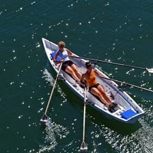 A rower propelling a boat with two sculls