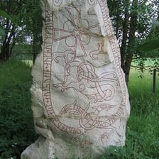 Runic symbols carved into an ancient stone.