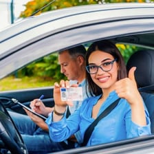 A student practicing driving with an instructor in a car