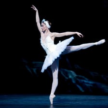 Ballet dancer performing a turn while balanced on one toe.