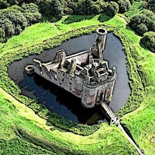 A medieval castle surrounded by a defensive moat.