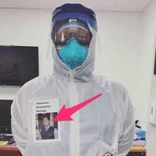 A healthcare worker wearing protective clothing, a mask, and gloves.