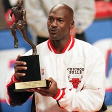 A sports player holding an award for Most Valuable Player.