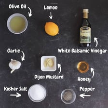 Extra-virgin olive oil alongside ingredients for a vinaigrette