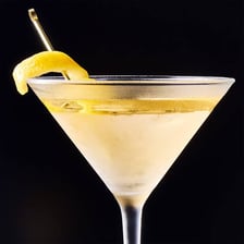 A Vesper martini garnished with a twist of lemon peel.