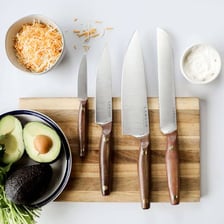 A small paring knife inserted into a wooden knife block