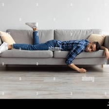 A tired person resting on a couch