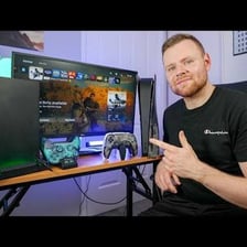 An Xbox console and a personal computer arranged for gaming.