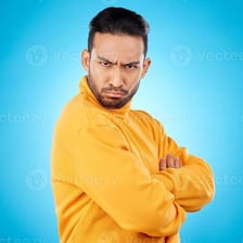 A visibly frustrated person standing with arms crossed