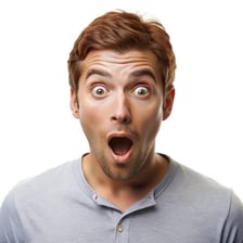 A person reacting with surprise after realizing they were tricked.