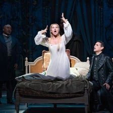 An opera singer performing onstage at the Metropolitan Opera.