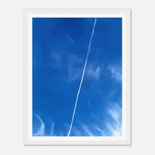 An airplane leaving a white contrail across the sky