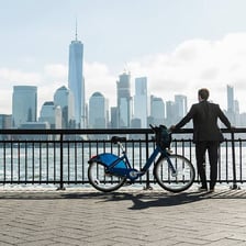 A cyclist riding a bicycle through an urban street