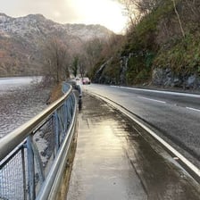 A roadway elevated above another road in a hilly landscape.