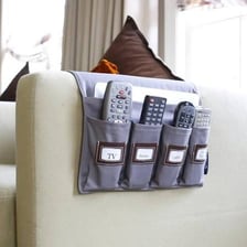 A sofa beside a television remote in a living room