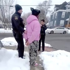 A police officer placing handcuffs on a person