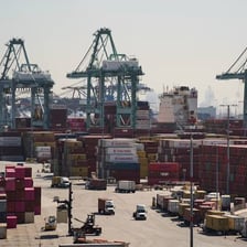 Cargo containers being inspected at a port customs facility