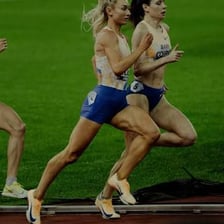 A runner moving around an oval track
