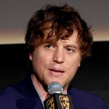 A person with thick, tousled hair.