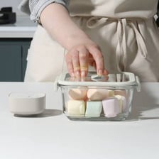 A person closing a container to make it airtight