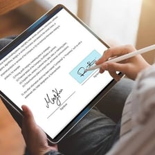 A person applying a digital signature to an electronic document.
