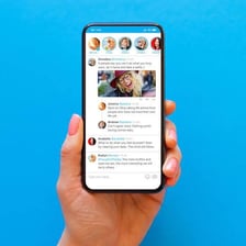 A smartphone displaying a scrolling social-media feed.
