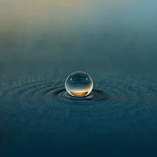 A single small water droplet shown in close-up.