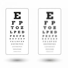An optometrist examining a patient’s eyes during a vision test.