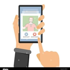 A hand swiping a dating-app profile to the left on a phone